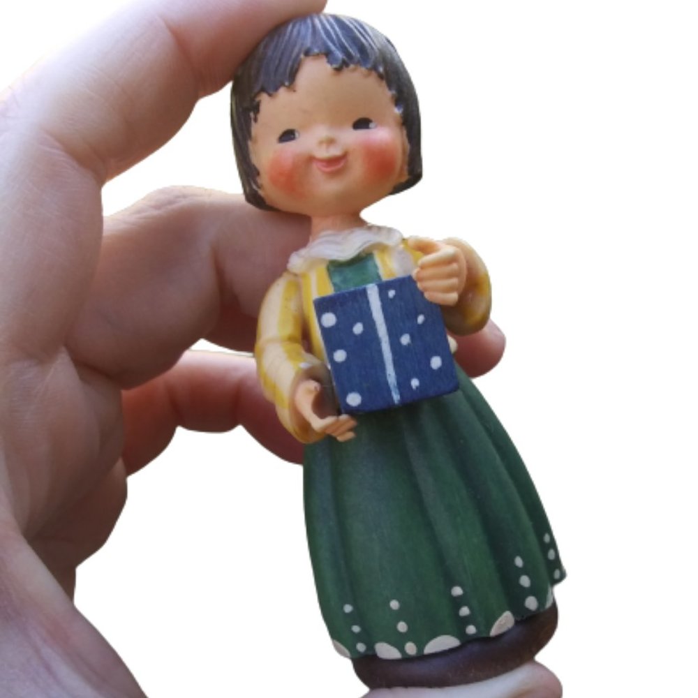 Hand carved wood little girl with a blue present  by Anri Italy  very sweet.